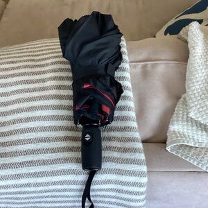 Compact Black Folding Umbrella with Red Trim by repel